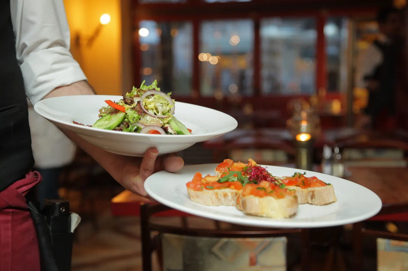 Restaurant staff serving plated meals